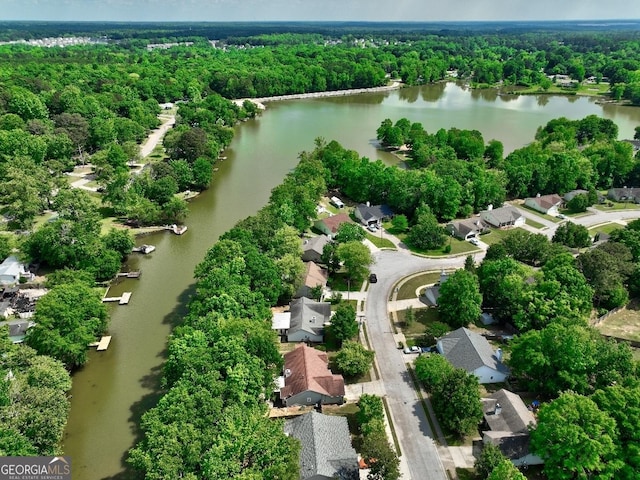 birds eye view of property featuring a residential view, a view of trees, and a water view
