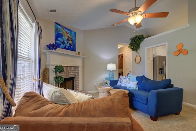 living area with lofted ceiling, a fireplace, light carpet, baseboards, and a ceiling fan