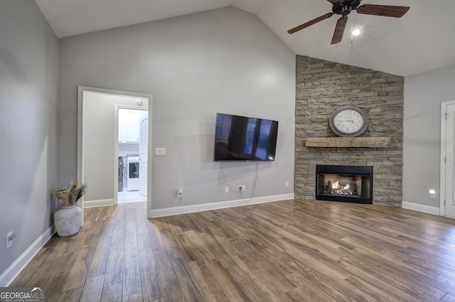 57 Round Rock Cir NE, Rome, GA 30161 - unfurnished living room featuring a stone fireplace, a ceiling fan, wood finished floors, and high vaulted ceiling