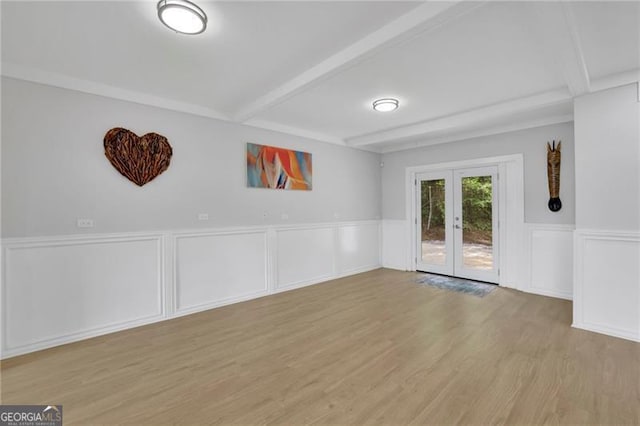 1839 Belcher Pl, Austell, GA 30168 - empty room with french doors, a wainscoted wall, beam ceiling, and light wood-type flooring