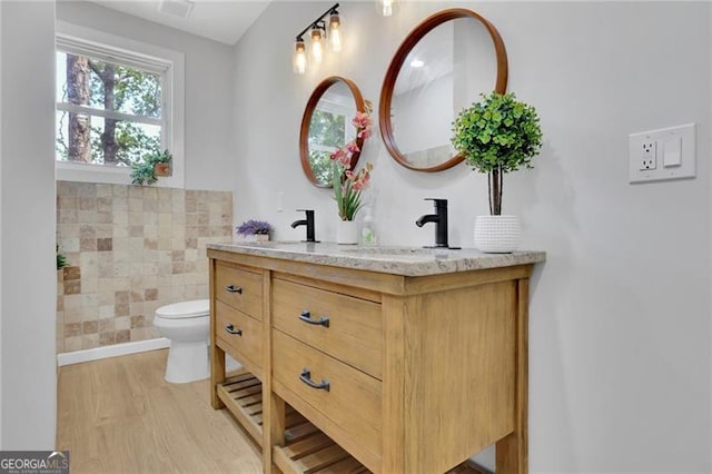 1839 Belcher Pl, Austell, GA 30168 - full bathroom featuring visible vents, double vanity, wood finished floors, toilet, and a sink