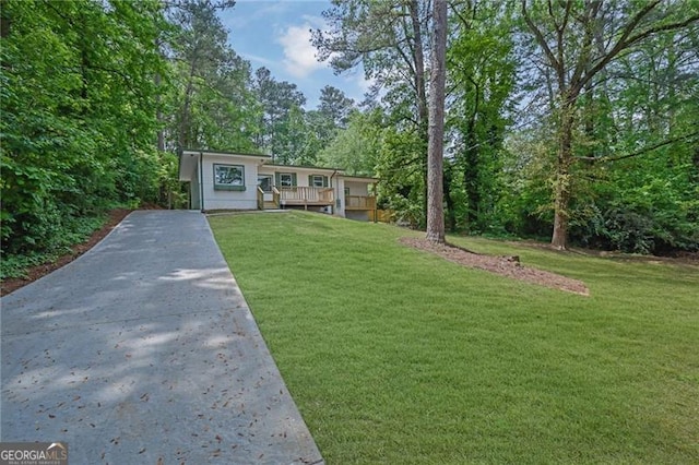 1839 Belcher Pl, Austell, GA 30168 - view of front of home with a wooden deck, driveway, and a front yard