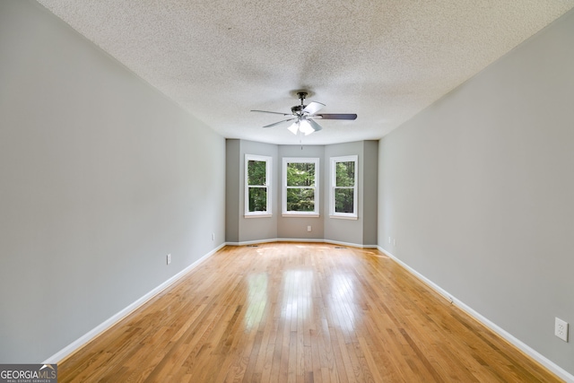 1094 Plantation Ct, Villa Rica, GA 30180 - empty room with light wood-style floors, a ceiling fan, and baseboards