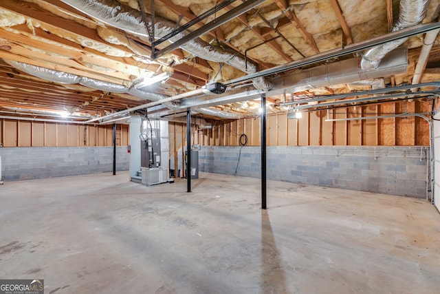 1094 Plantation Ct, Villa Rica, GA 30180 - unfinished below grade area featuring heating unit, concrete block wall, and water heater