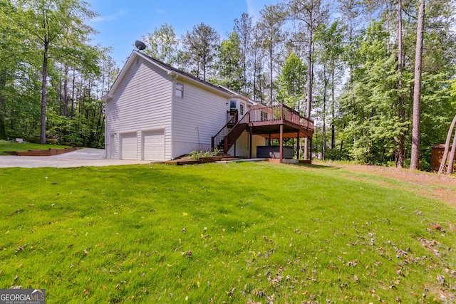 1094 Plantation Ct, Villa Rica, GA 30180 - back of property with a lawn, a wooden deck, stairway, concrete driveway, and an attached garage