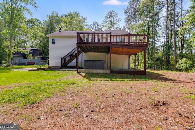 1094 Plantation Ct, Villa Rica, GA 30180 - back of house with a jacuzzi, a deck, stairway, central air condition unit, and a lawn