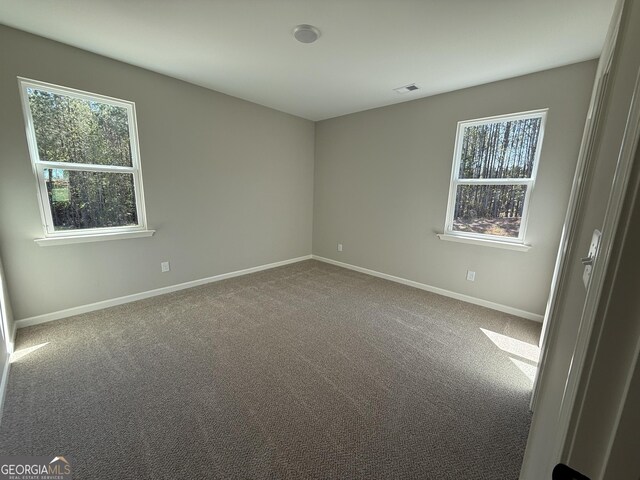 788 Traveler Ln, Williamson, GA 30292 - carpeted empty room featuring baseboards