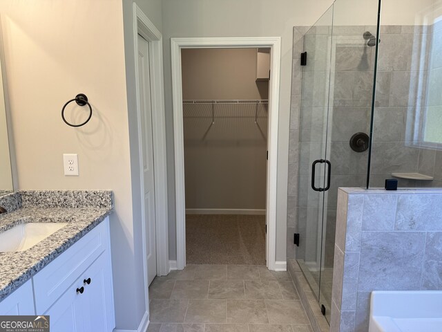 788 Traveler Ln, Williamson, GA 30292 - full bath featuring vanity, a walk in closet, baseboards, and a stall shower