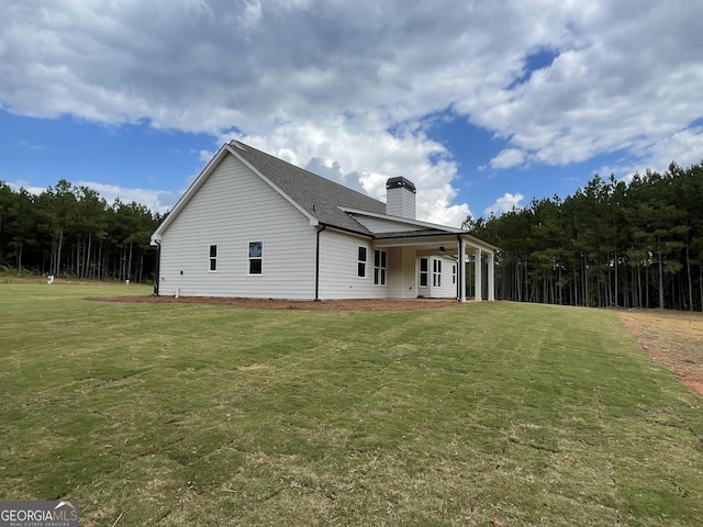 788 Traveler Ln, Williamson, GA 30292 - back of property featuring a lawn, ceiling fan, and a chimney