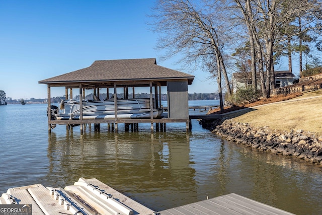 dock area featuring boat lift and a water view