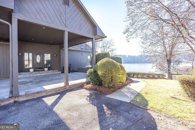 view of yard featuring a water view and visible vents