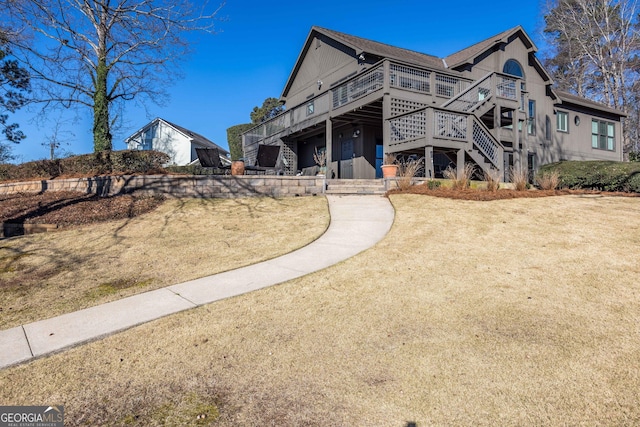 view of front facade featuring stairs and a deck