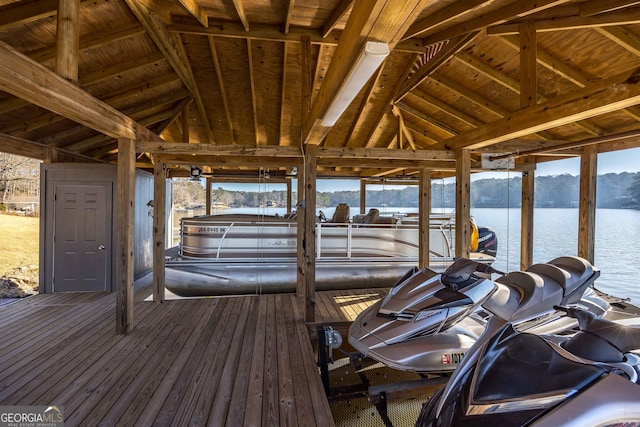 dock area featuring boat lift and a water view