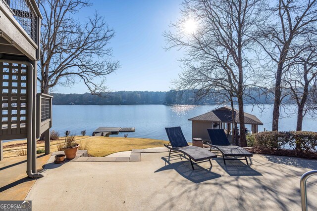 view of patio / terrace featuring a water view and a boat dock