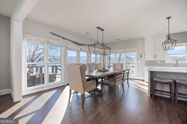 302 Odom Dr, Hamilton, GA 31811 - dining room with a chandelier, dark wood-style floors, and baseboards