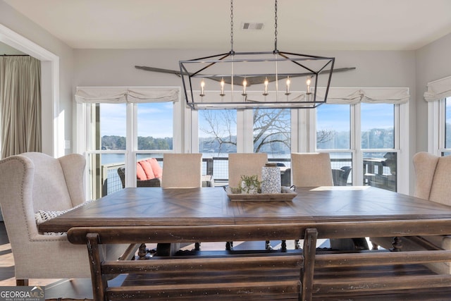 dining room featuring an inviting chandelier and visible vents