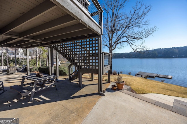 view of patio / terrace featuring a water view, stairway, and a dock