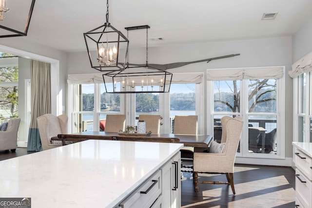 302 Odom Dr, Hamilton, GA 31811 - dining area with a chandelier, plenty of natural light, and dark wood finished floors