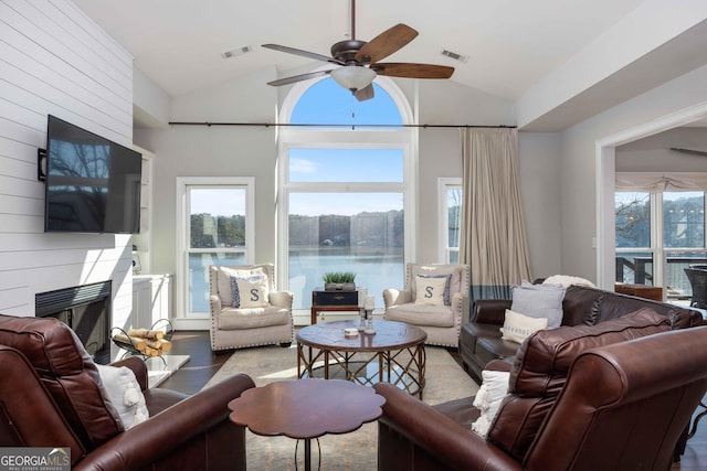 302 Odom Dr, Hamilton, GA 31811 - living room with lofted ceiling, ceiling fan, a large fireplace, and wood finished floors