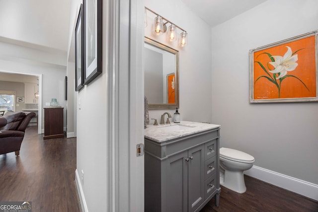 302 Odom Dr, Hamilton, GA 31811 - bathroom featuring wood finished floors, baseboards, toilet, and vanity