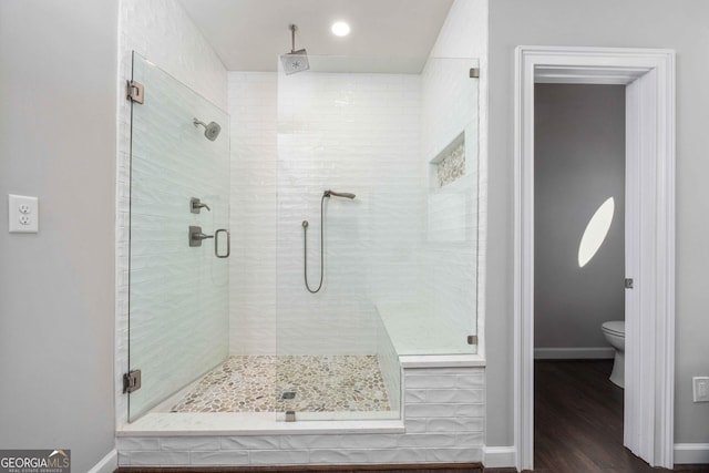302 Odom Dr, Hamilton, GA 31811 - full bathroom with a shower stall, wood finished floors, baseboards, and toilet