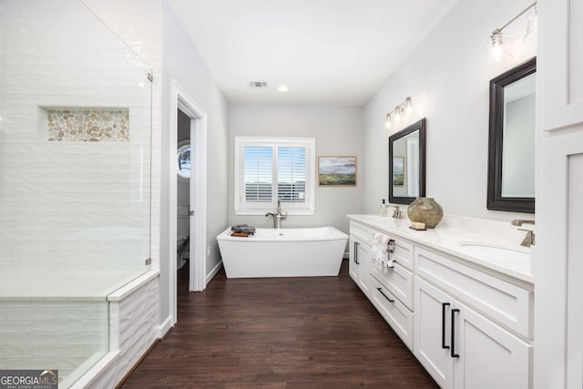 302 Odom Dr, Hamilton, GA 31811 - full bath with a freestanding tub, wood finished floors, double vanity, and a tile shower