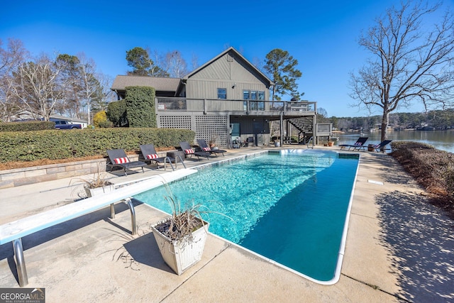 302 Odom Dr, Hamilton, GA 31811 - swimming pool featuring stairs, a diving board, a patio, and a deck