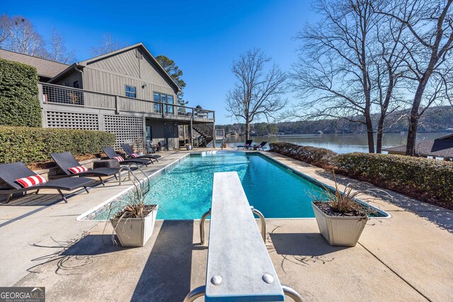 302 Odom Dr, Hamilton, GA 31811 - swimming pool featuring stairs, a diving board, a deck with water view, and a patio