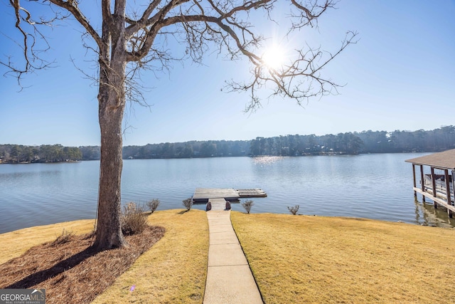 dock area featuring a water view and a yard