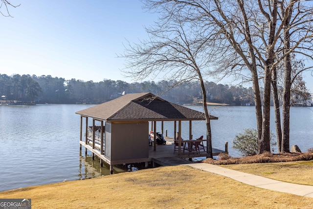 dock area featuring a water view, a yard, and boat lift