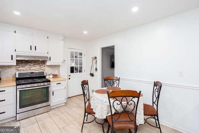 4812 Pamela Ct, Acworth, GA 30101 - kitchen with white cabinets, stainless steel gas range oven, light countertops, tasteful backsplash, and under cabinet range hood