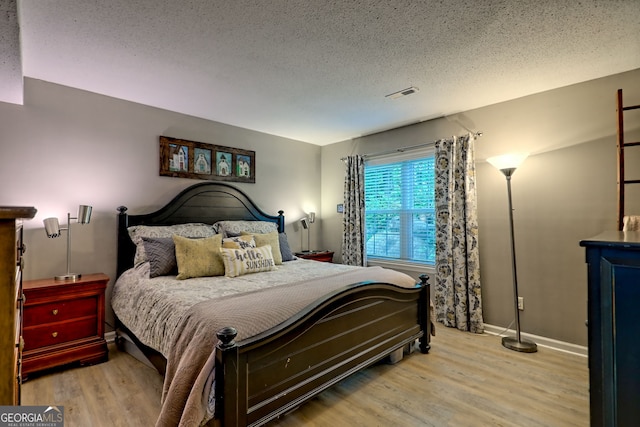230 Stornoway Dr Unit 1, Clayton, GA 30525 - bedroom with wood finished floors and a textured ceiling