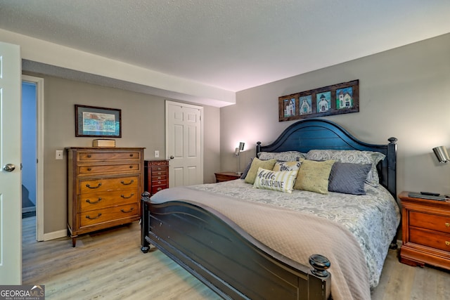 bedroom featuring light wood-style flooring and baseboards