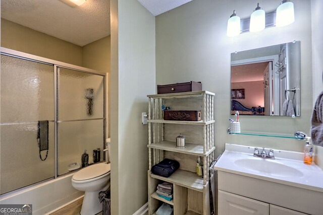 full bath featuring toilet, vanity, shower / bath combination with glass door, and wood finished floors