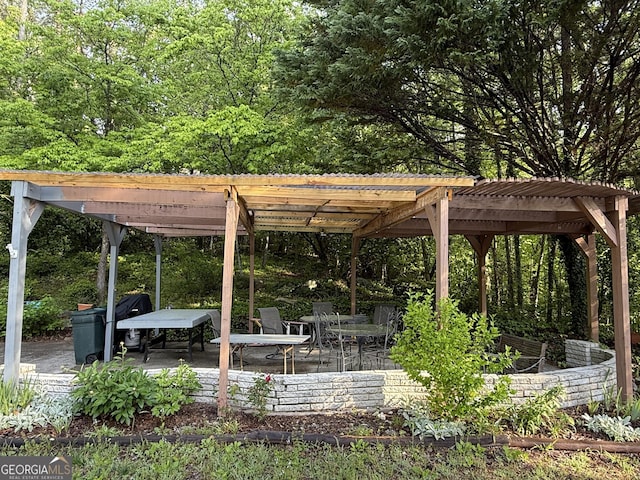 view of community featuring a pergola and a patio area