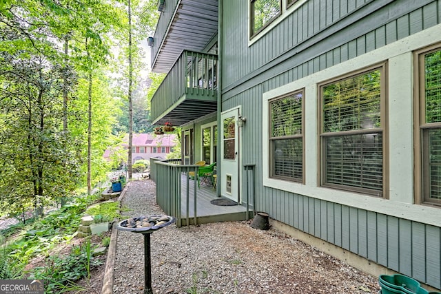 view of property exterior with a balcony and a deck