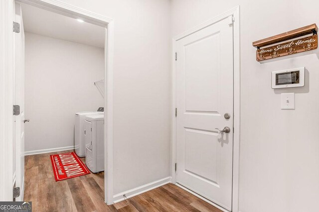 112 Leveret Rd, Locust Grove, GA 30248 - clothes washing area featuring baseboards, laundry area, washer and clothes dryer, and wood finished floors