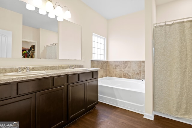138 Yonah Way, Dallas, GA 30132 - full bath featuring wood finished floors, a bath, double vanity, a spacious closet, and curtained shower