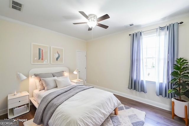 bedroom featuring ornamental molding, wood finished floors, baseboards, and a ceiling fan