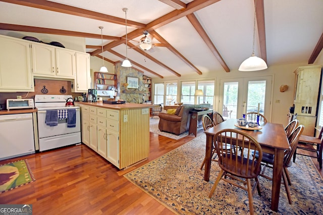 kitchen featuring a ceiling fan, wood finished floors, a peninsula, vaulted ceiling with beams, and white appliances