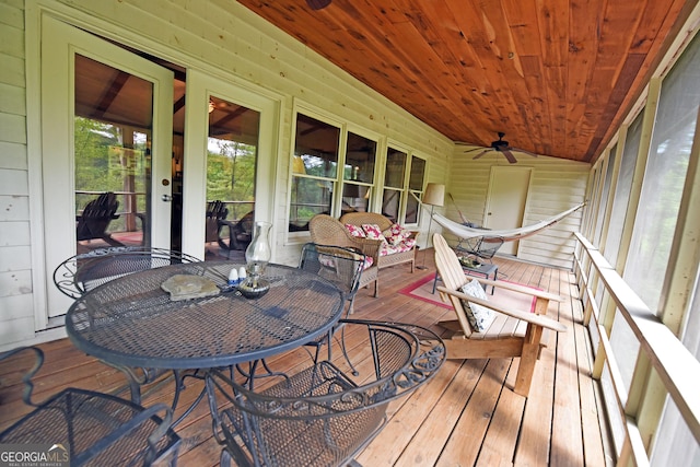 wooden terrace featuring a ceiling fan and outdoor dining space