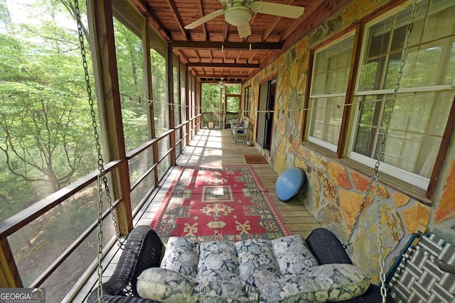 sunroom / solarium featuring ceiling fan