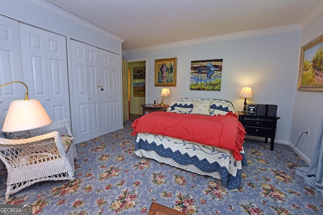 carpeted bedroom featuring crown molding, baseboards, and a closet