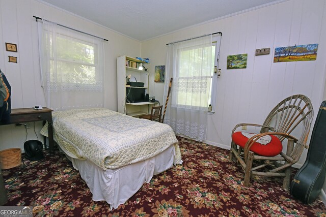 bedroom with ornamental molding, carpet, and multiple windows