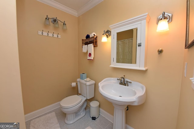 bathroom featuring baseboards, ornamental molding, tile patterned floors, and toilet