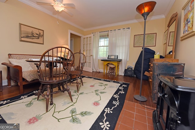 living area with crown molding, baseboards, ceiling fan, and wood finished floors