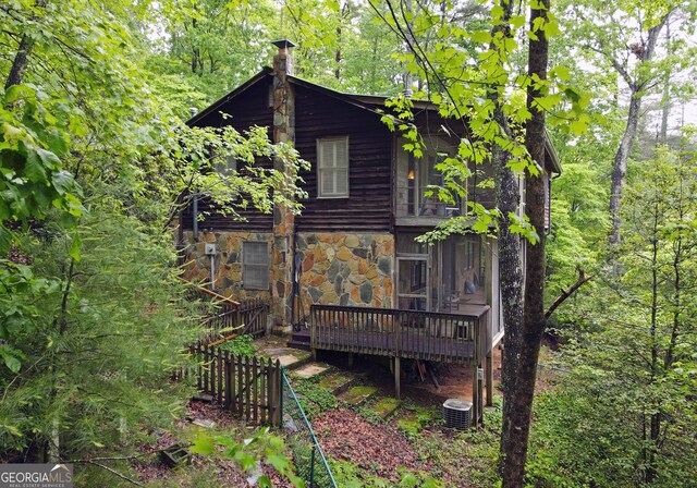 66 Pine Ridge Ct, Ellijay, GA 30536 - view of property exterior featuring central AC, a deck, a chimney, and stone siding