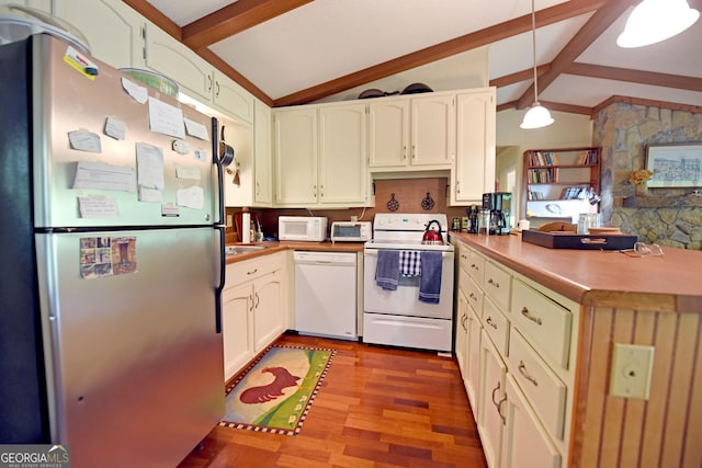 kitchen featuring hanging light fixtures, white appliances, a peninsula, vaulted ceiling with beams, and wood finished floors