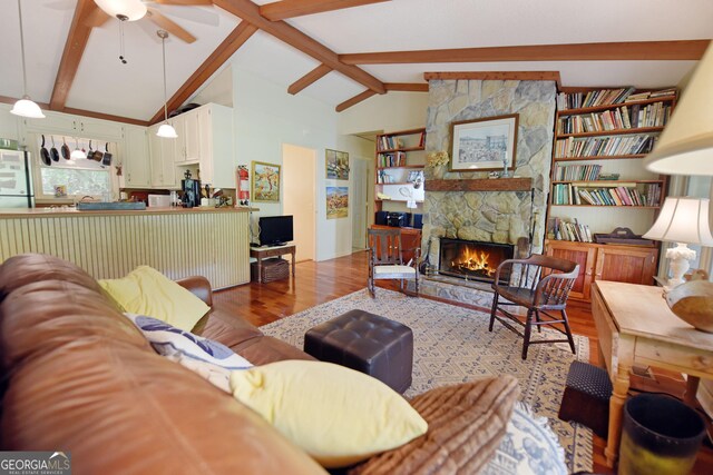 66 Pine Ridge Ct, Ellijay, GA 30536 - living area with a fireplace, ceiling fan, lofted ceiling with beams, and wood finished floors