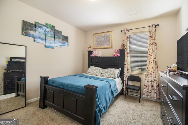 bedroom with light colored carpet, baseboards, and visible vents